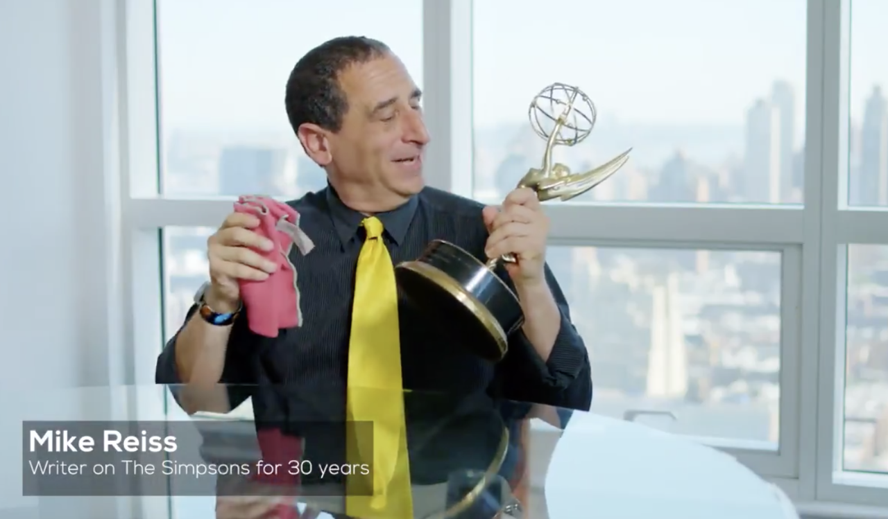 The Simpsons writer Mike Reiss with an Emmy Award trophy.