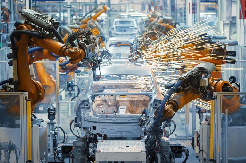 Robot assembly line welding an automobile.