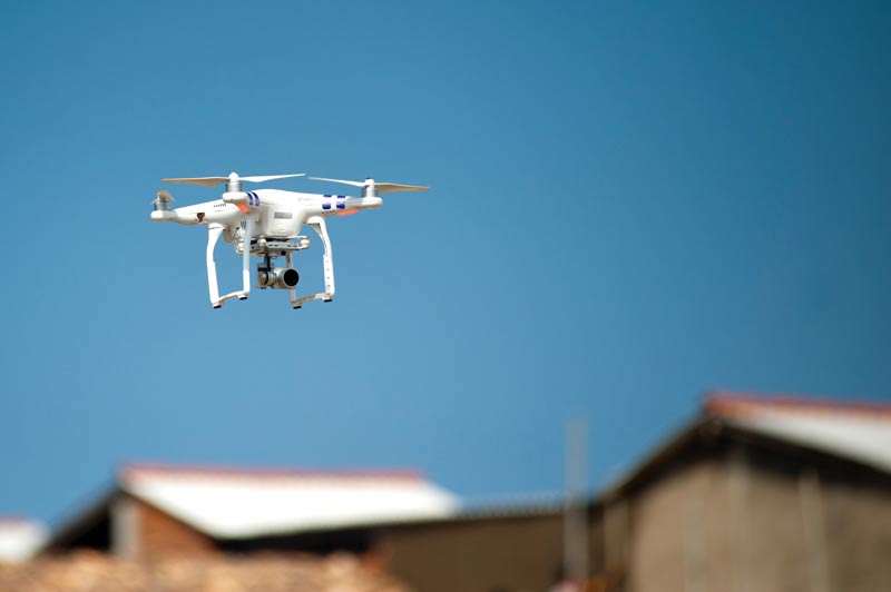 Drone flying over rural buildings.
